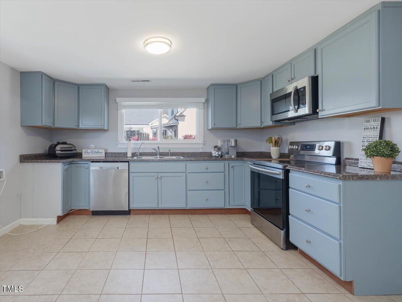 9117 Penny Road Raleigh, NC 27606 - Photo 57 of 72 a kitchen with stainless steel appliances granite countertop a stove sink and cabinets
