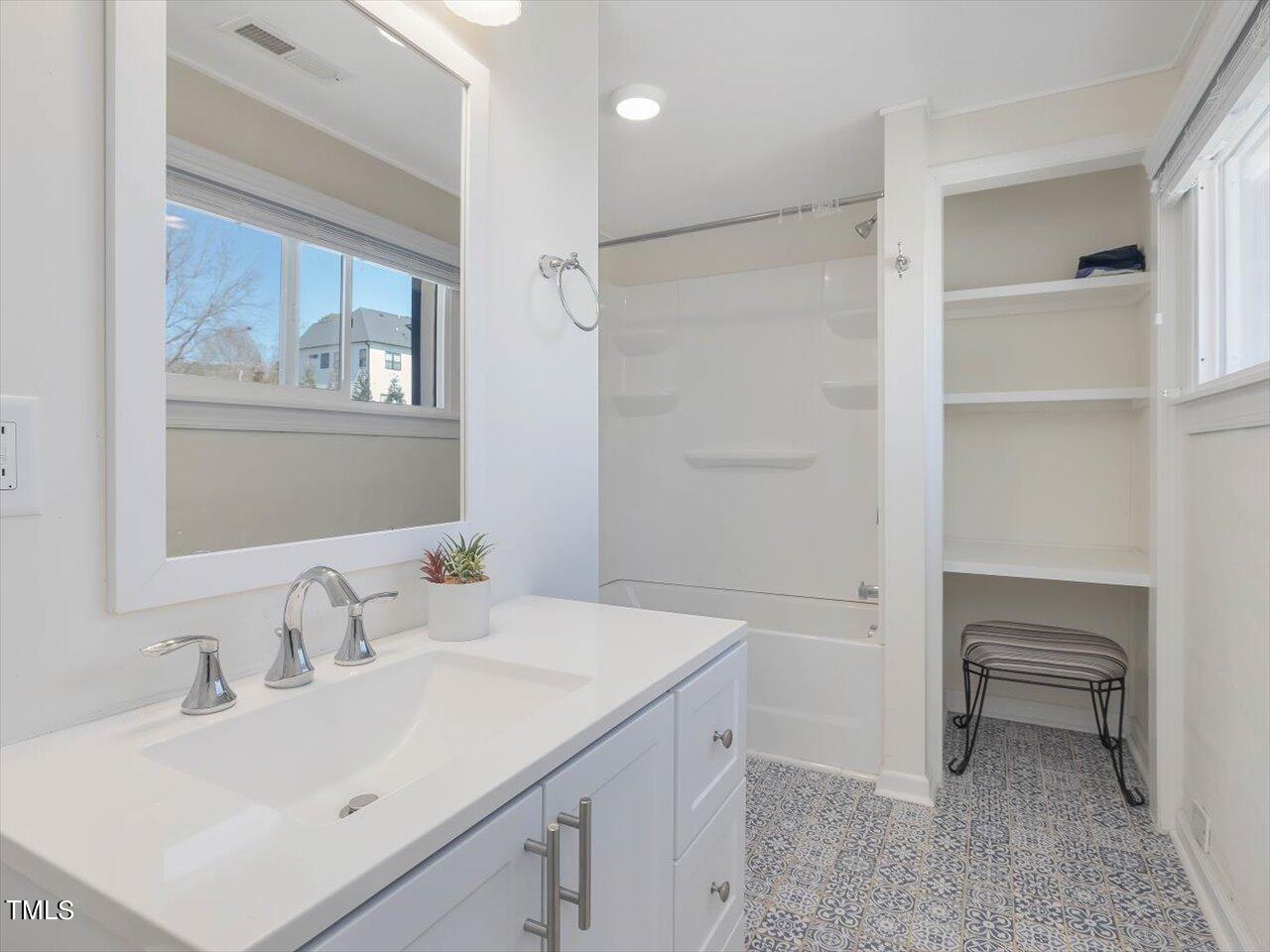 9117 Penny Road Raleigh, NC 27606 - Photo 63 of 72 a bathroom with a sink toilet and a mirror