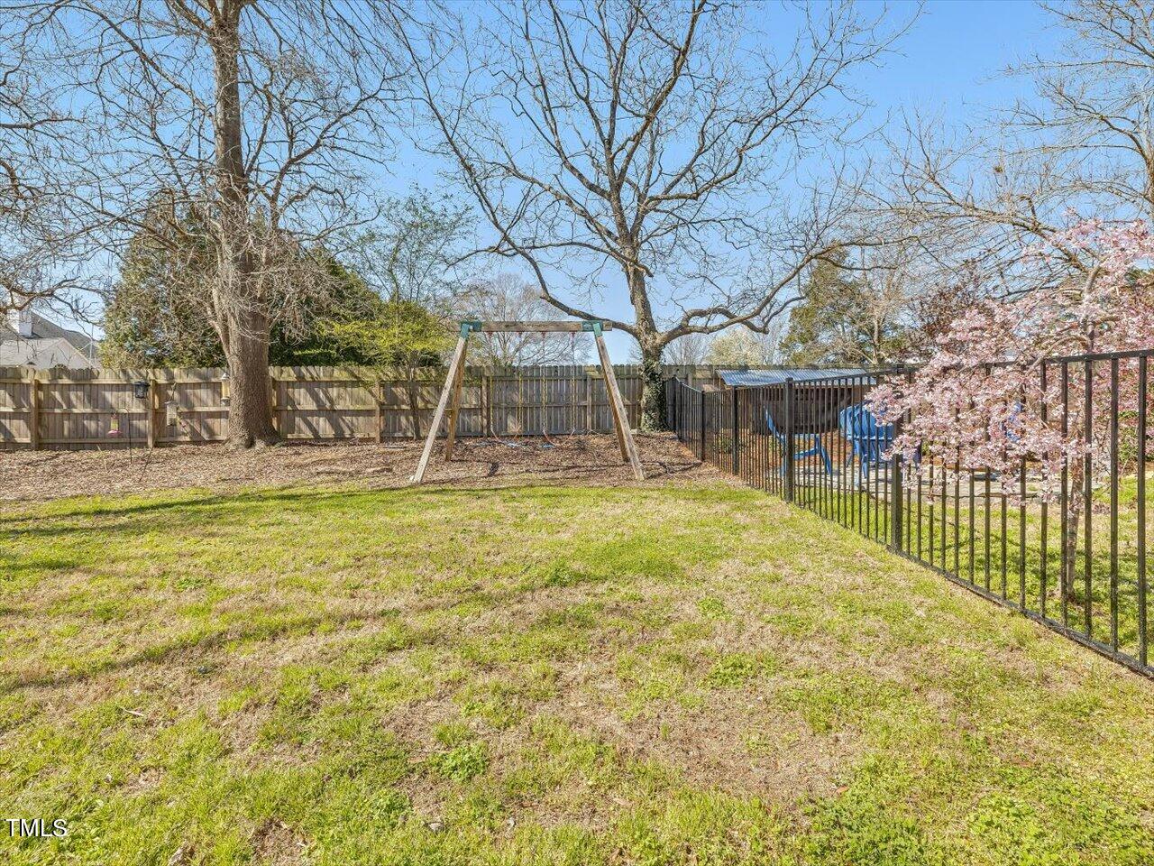 9117 Penny Road Raleigh, NC 27606 - Photo 66 of 72 a view of a yard with brick wall and large trees