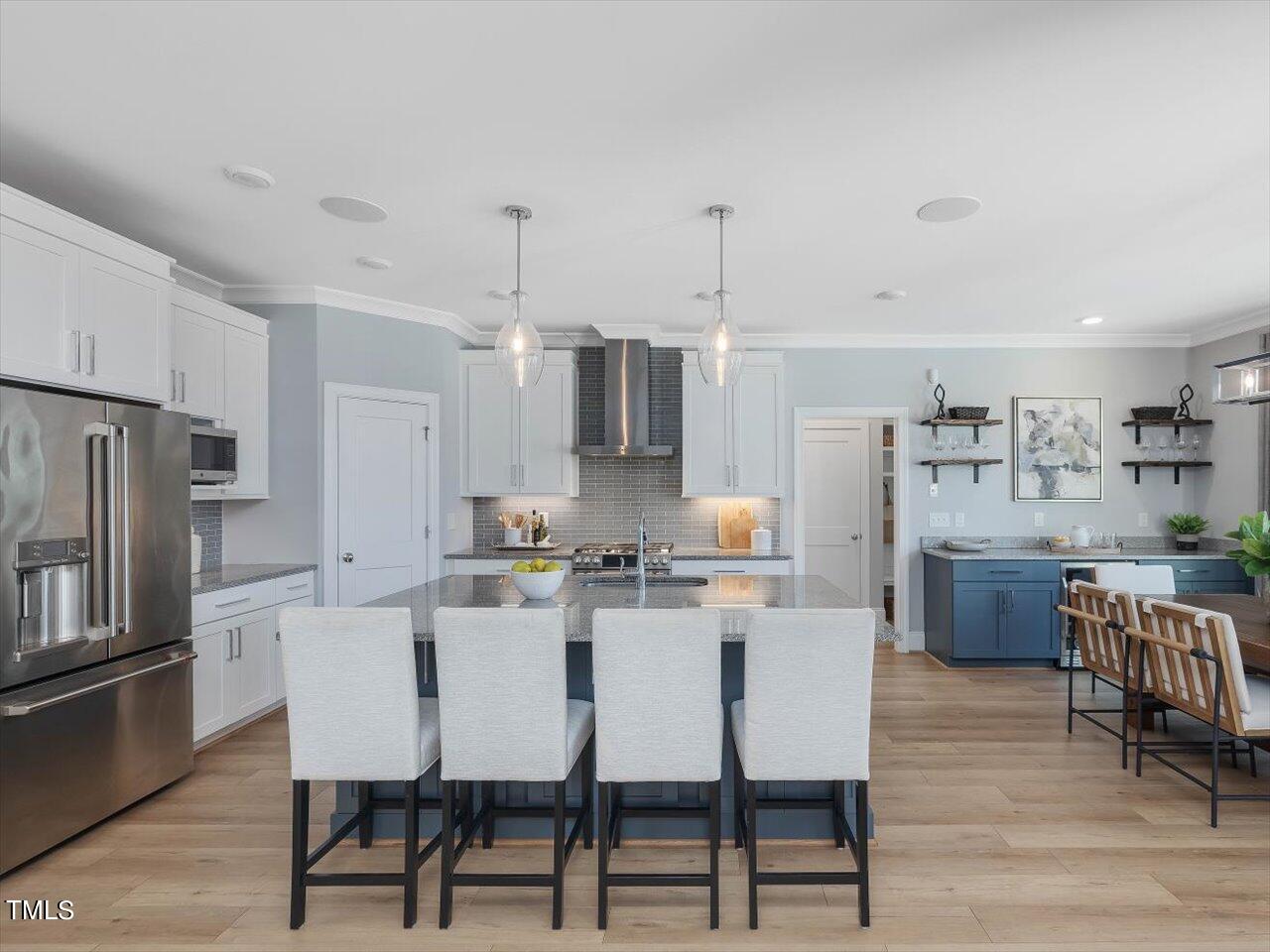 9117 Penny Road Raleigh, NC 27606 - Photo 9 of 72 a dining room with stainless steel appliances kitchen island granite countertop a dining table chairs and a refrigerator