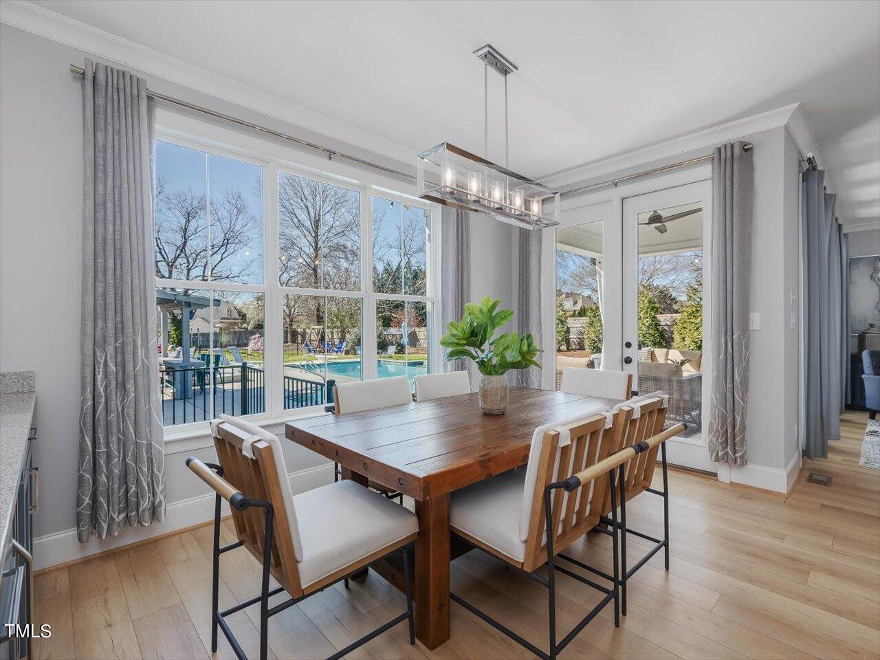 9117 Penny Road Raleigh, NC 27606 - Photo 10 of 72 a view of a dining room with furniture window and wooden floor