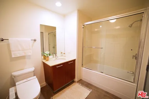 a bathroom with a sink mirror vanity and toilet