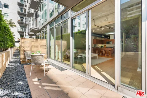 a view of a patio with a dining table and chairs