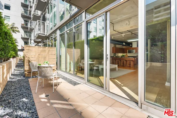 a view of a patio with a dining table and chairs