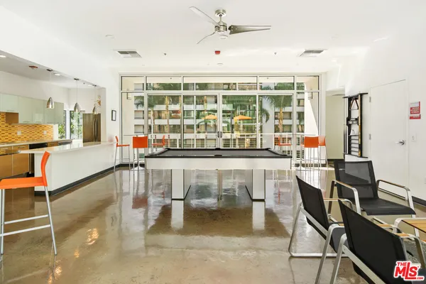 a dining room with wooden floor and a floor to ceiling window