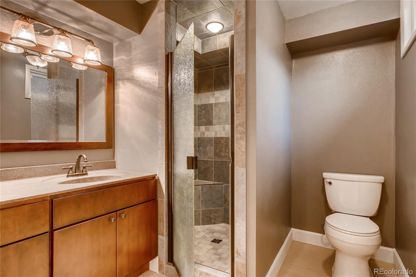 3315 West Pimlico Avenue Englewood, CO 80110 - Photo 25 of 35 a bathroom with a toilet sink and shower
