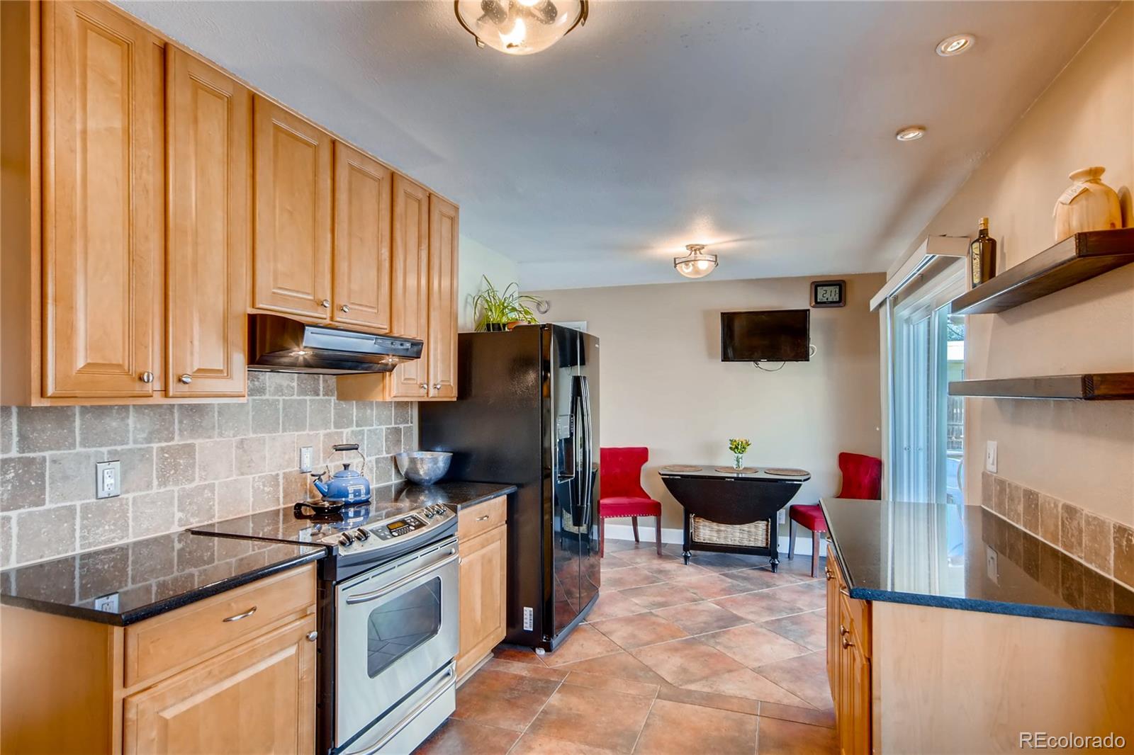 3315 West Pimlico Avenue Englewood, CO 80110 - Photo 9 of 35 a kitchen with stainless steel appliances granite countertop a sink stove and refrigerator