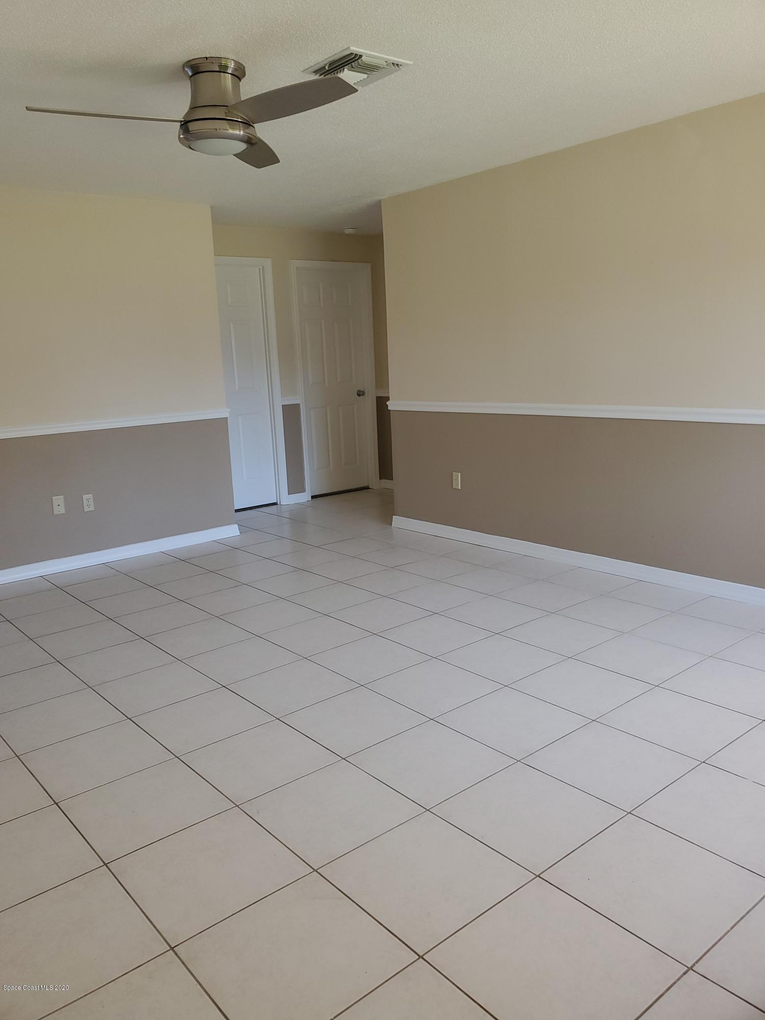 890 Kings Post Road Rockledge, FL 32955 - Photo 3 of 14 Living Room with chair rail