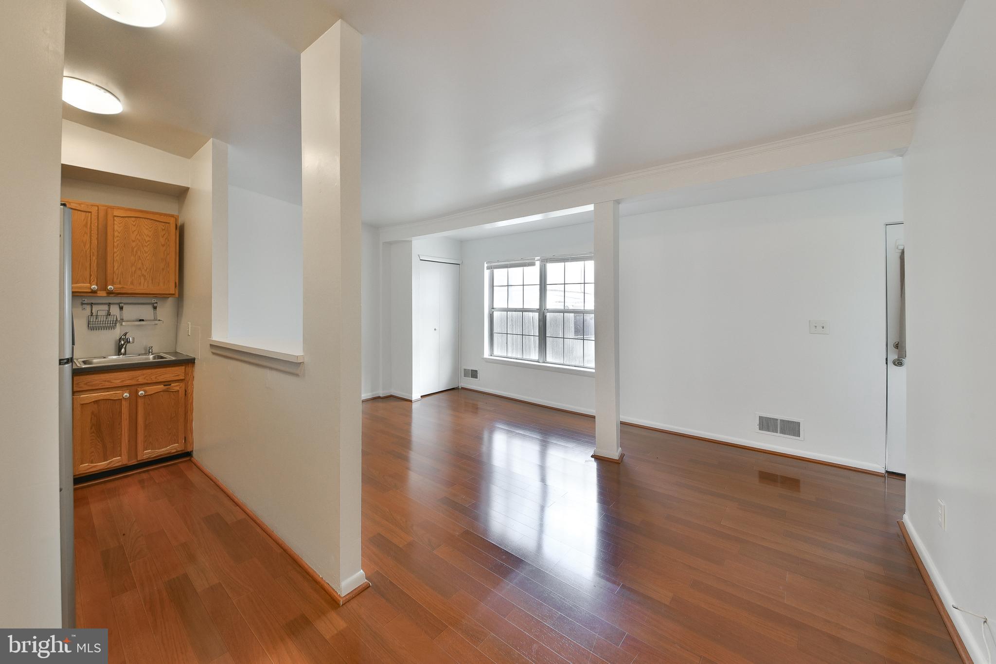 357 Lyceum Avenue Philadelphia, PA 19128 - Photo 13 of 21 a view of an empty room with a window and wooden floor