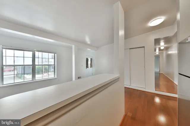 a room with a bed and a large window