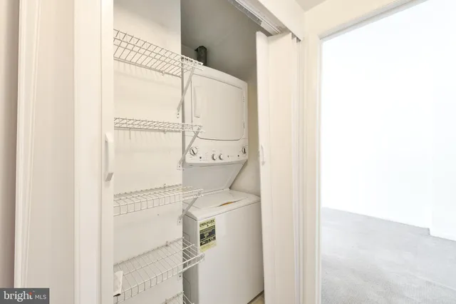 a utility room with a shower and a mirror