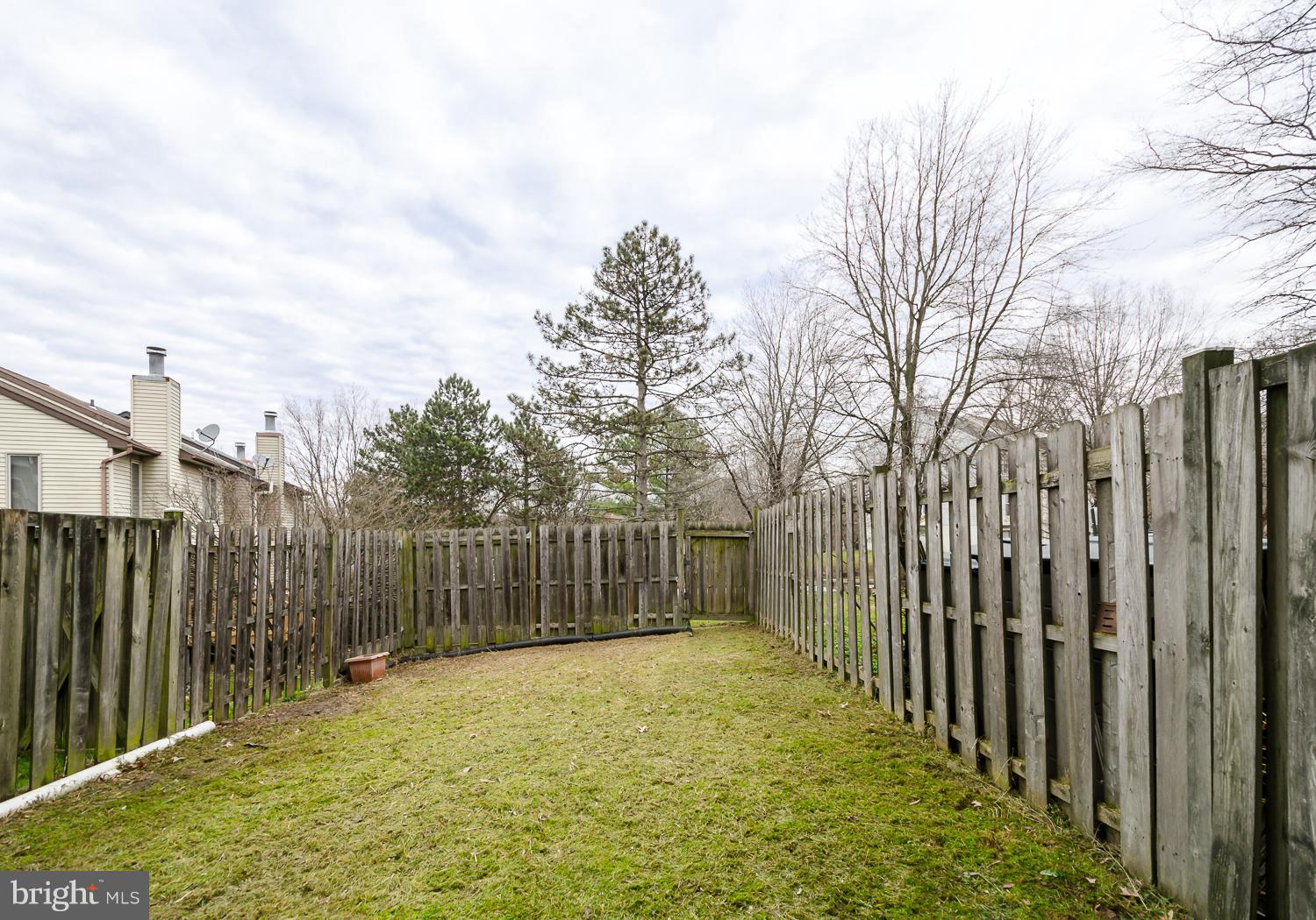 9502 Clocktower Lane Columbia, MD 21046 - Photo 11 of 12 a view of a backyard with fence