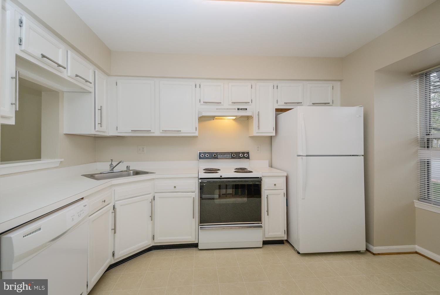 9502 Clocktower Lane Columbia, MD 21046 - Photo 3 of 12 a kitchen with stainless steel appliances granite countertop white refrigerator stove a sink and dishwasher