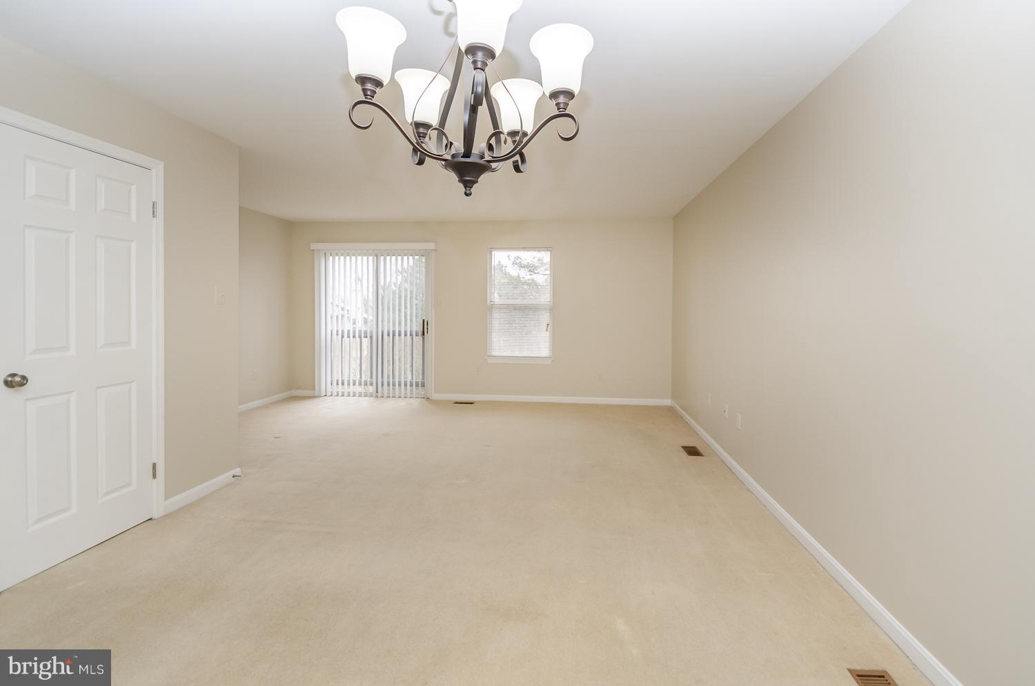 9502 Clocktower Lane Columbia, MD 21046 - Photo 4 of 12 a view of empty room with chandelier