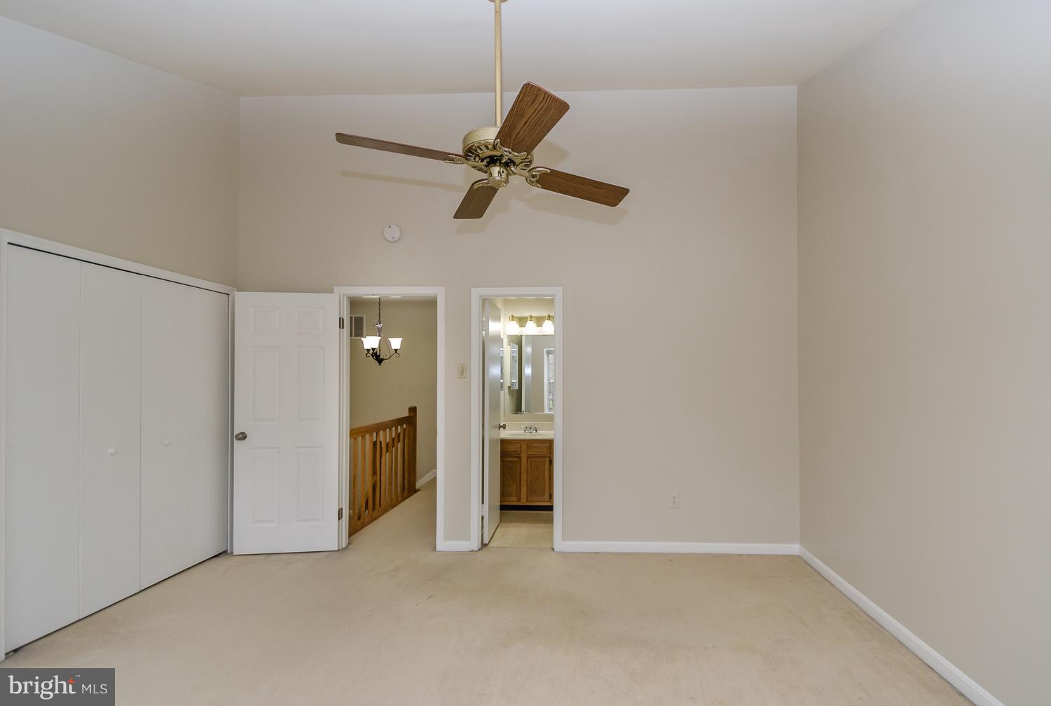 9502 Clocktower Lane Columbia, MD 21046 - Photo 9 of 12 an empty room with chandelier fan and windows