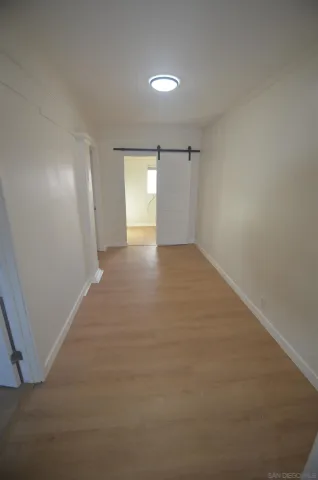 a view of an empty room and a window