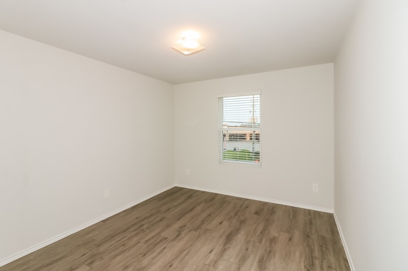 21626 Mamba Way Houston, TX 77073 - Photo 8 of 12 an empty room with wooden floor and windows