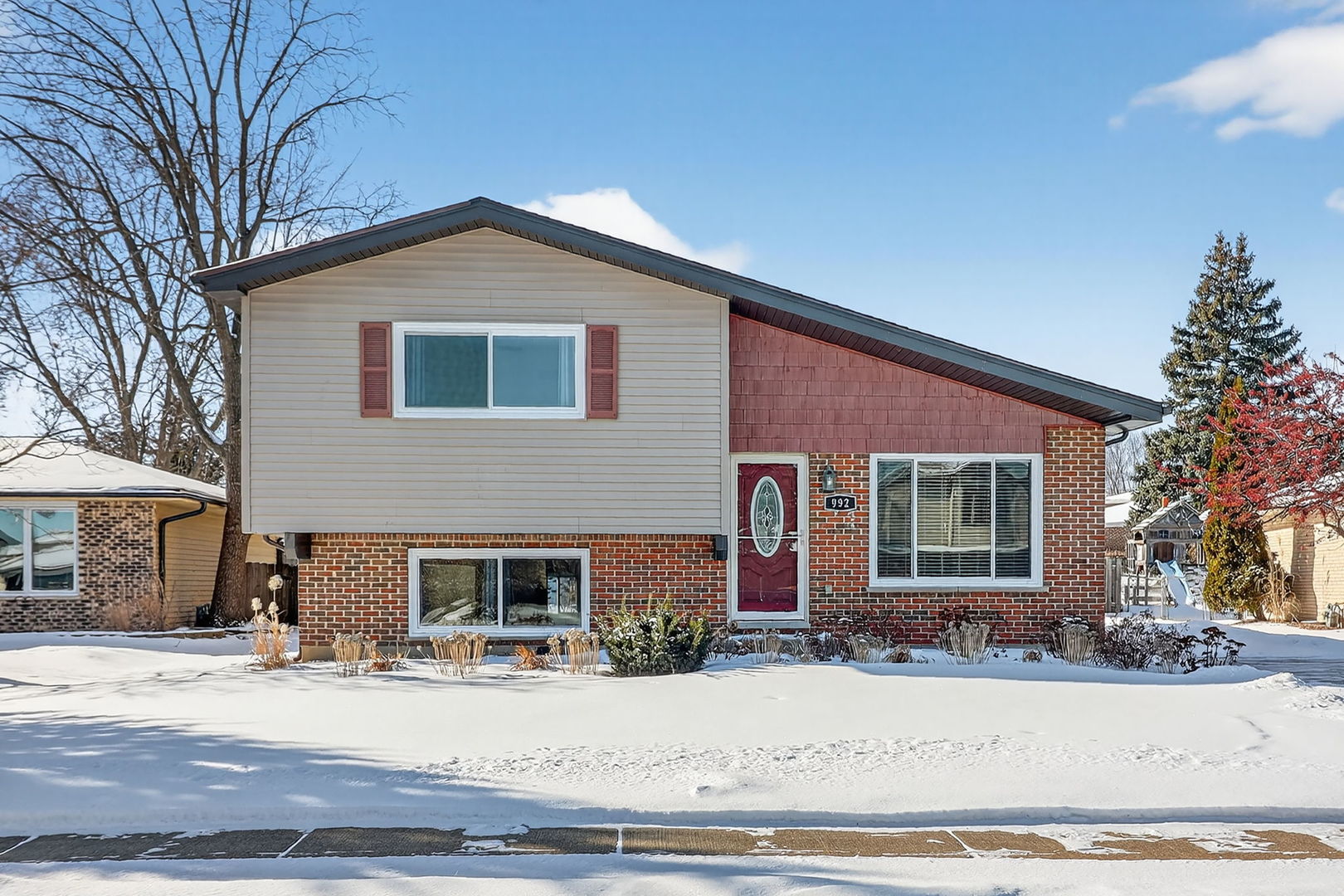 992 Navajo Street Carol Stream, IL 60188 - Photo 1 of 28 a front view of a house with a yard and garage