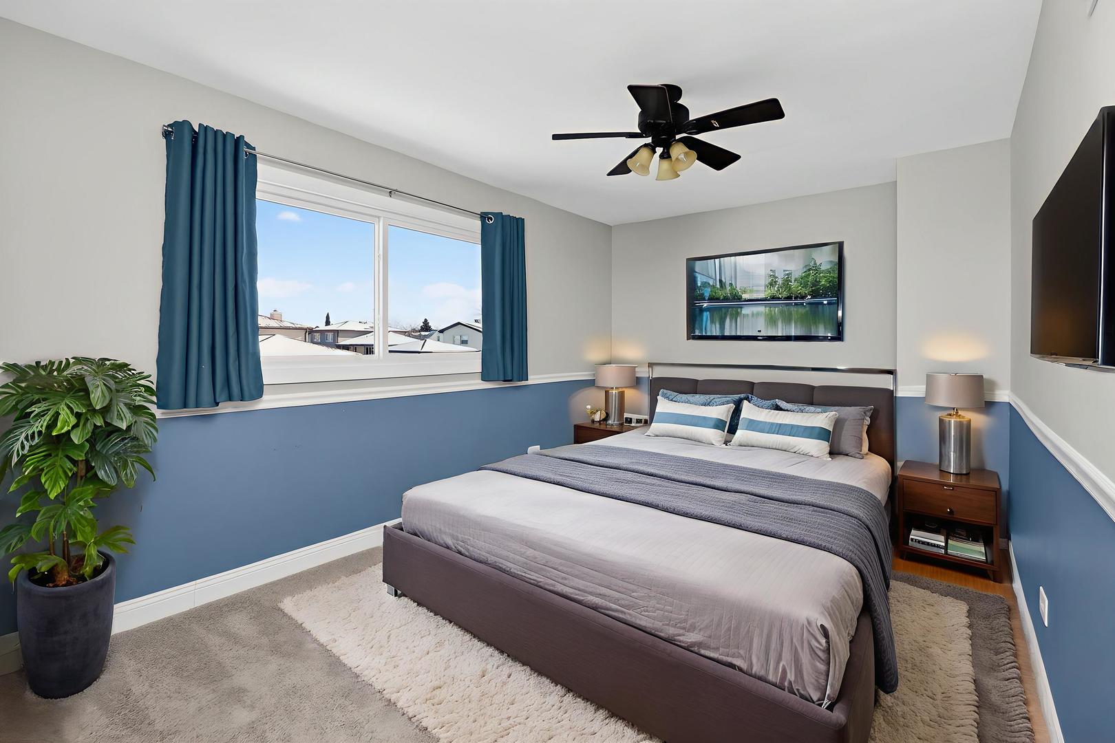 992 Navajo Street Carol Stream, IL 60188 - Photo 12 of 28 a bedroom with a bed window and a flat screen tv
