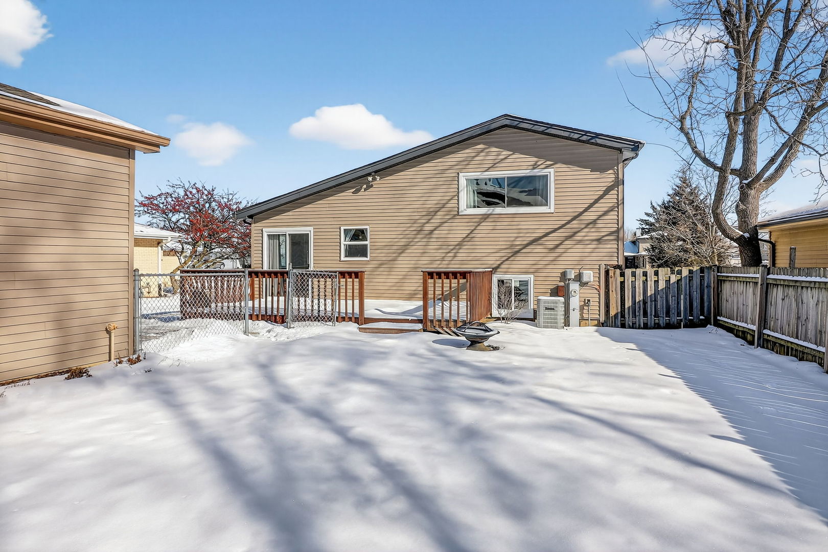 992 Navajo Street Carol Stream, IL 60188 - Photo 20 of 28 a view of a house with a snow in the yard