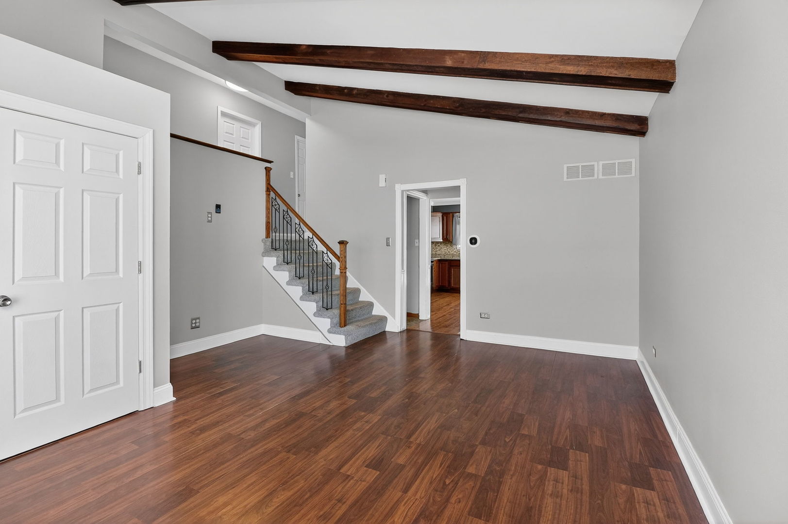 992 Navajo Street Carol Stream, IL 60188 - Photo 5 of 28 a view of an empty room with wooden floor and stairs