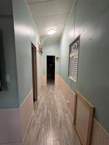 a view of a kitchen with a sink and a refrigerator