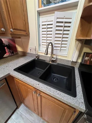 a white toilet sitting next to a bathroom sink and a shower