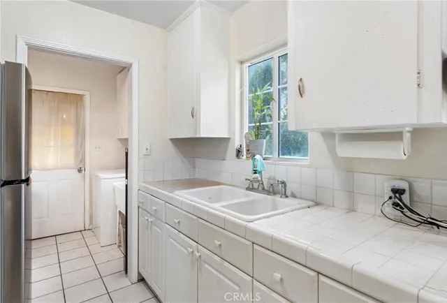 a kitchen with a sink cabinets and appliances