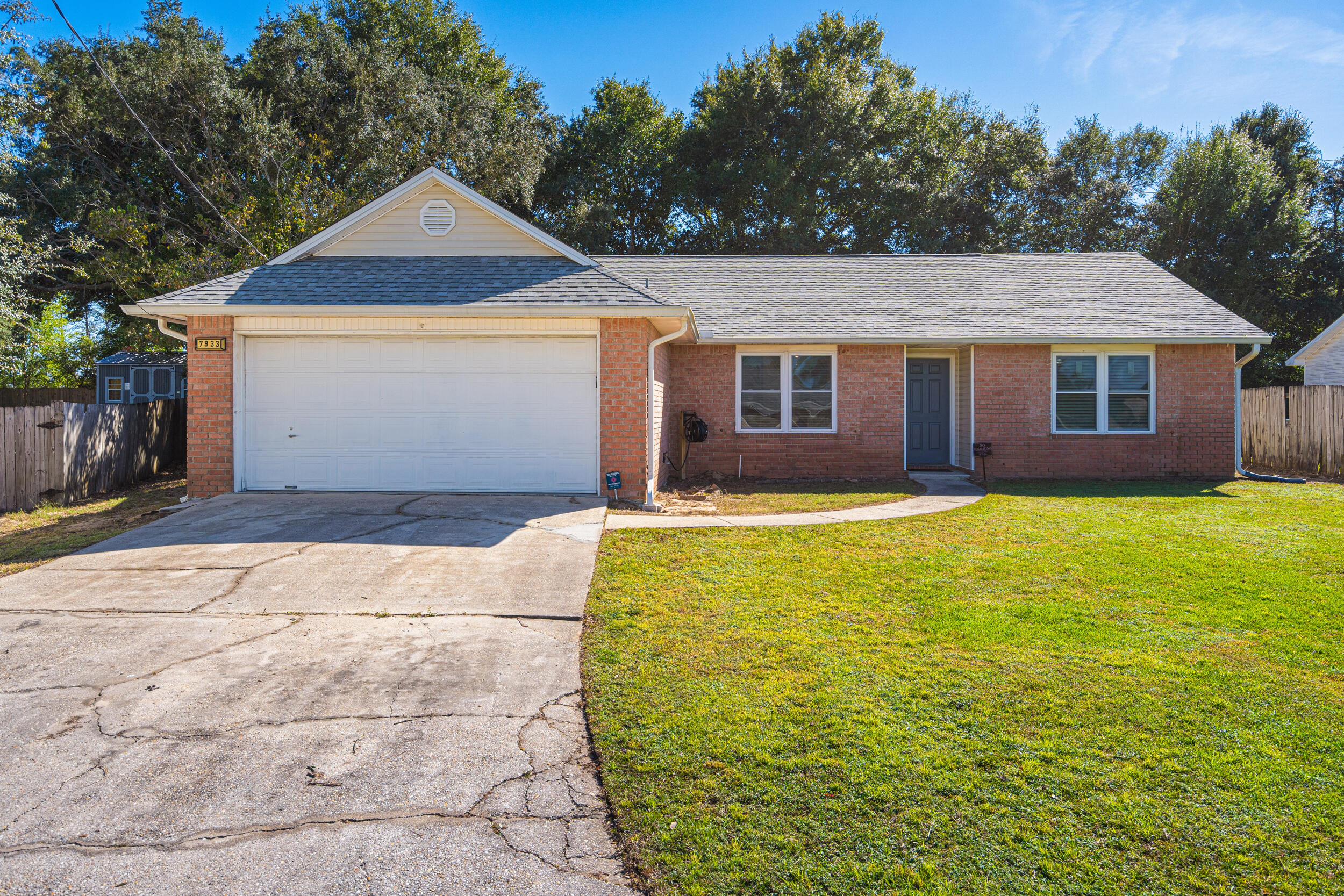 7933 Skyview Boulevard Navarre, FL 32566 - Photo 1 of 38 a front view of house with yard and trees in the background