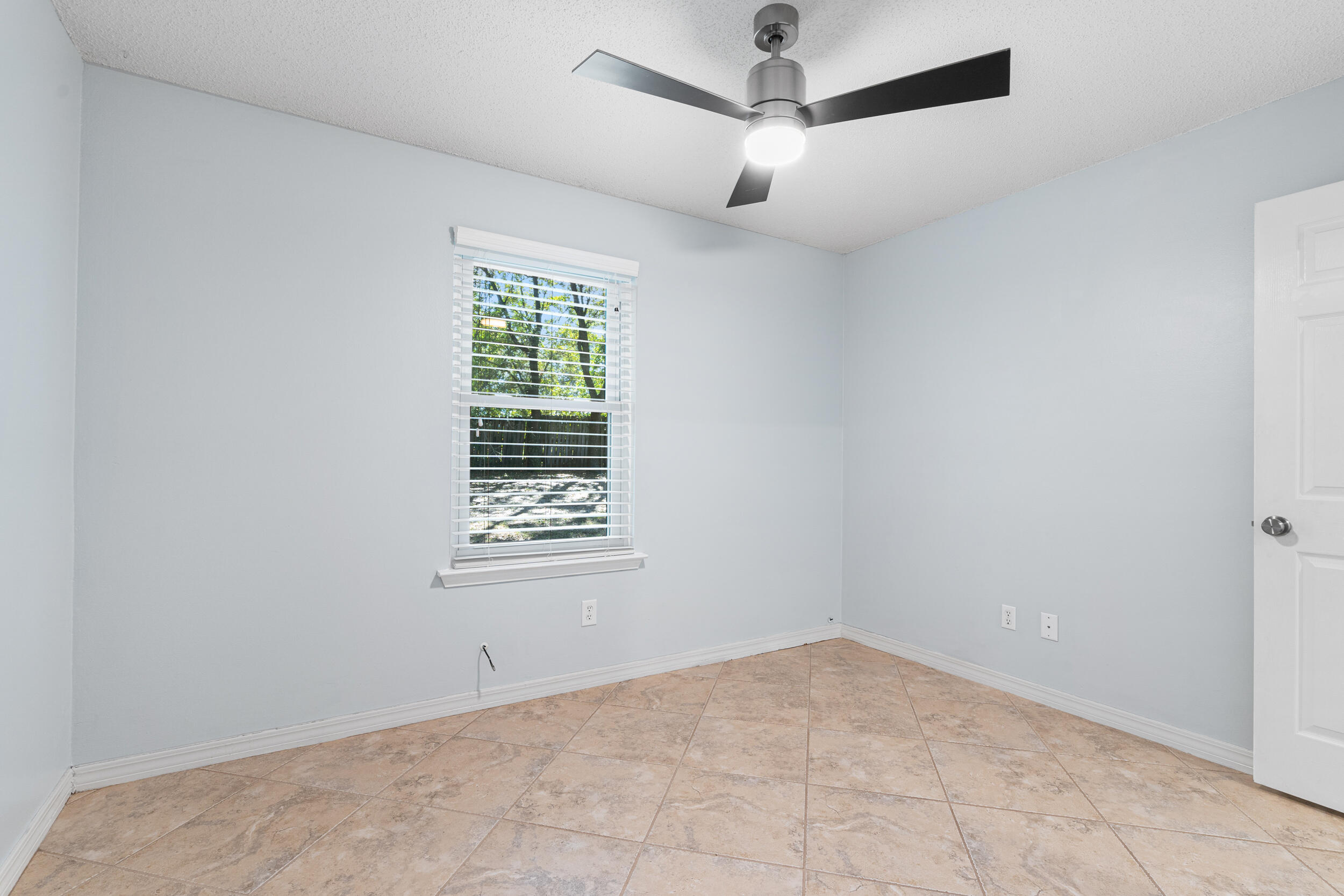 7933 Skyview Boulevard Navarre, FL 32566 - Photo 19 of 38 an empty room with a window and a fan