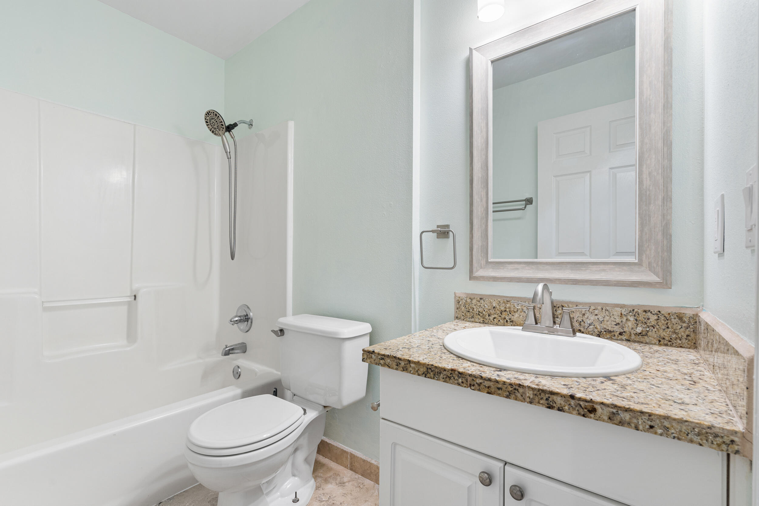 7933 Skyview Boulevard Navarre, FL 32566 - Photo 20 of 38 a bathroom with a granite countertop sink toilet and shower