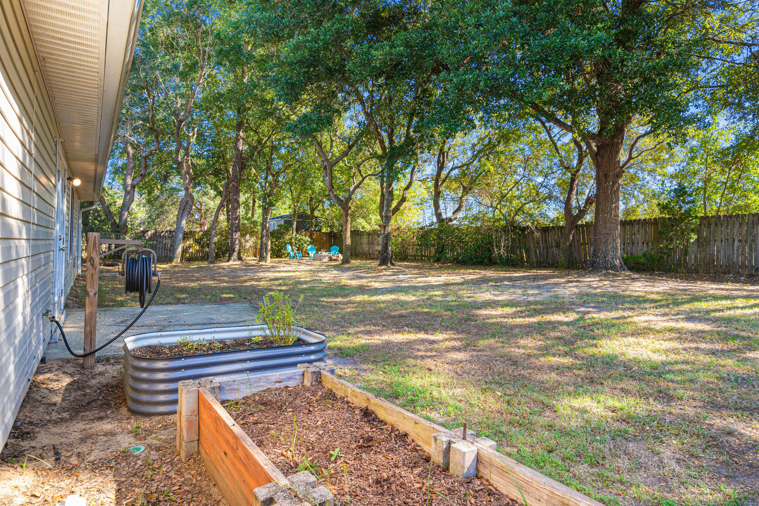 7933 Skyview Boulevard Navarre, FL 32566 - Photo 29 of 38 a view of a yard with plants and trees