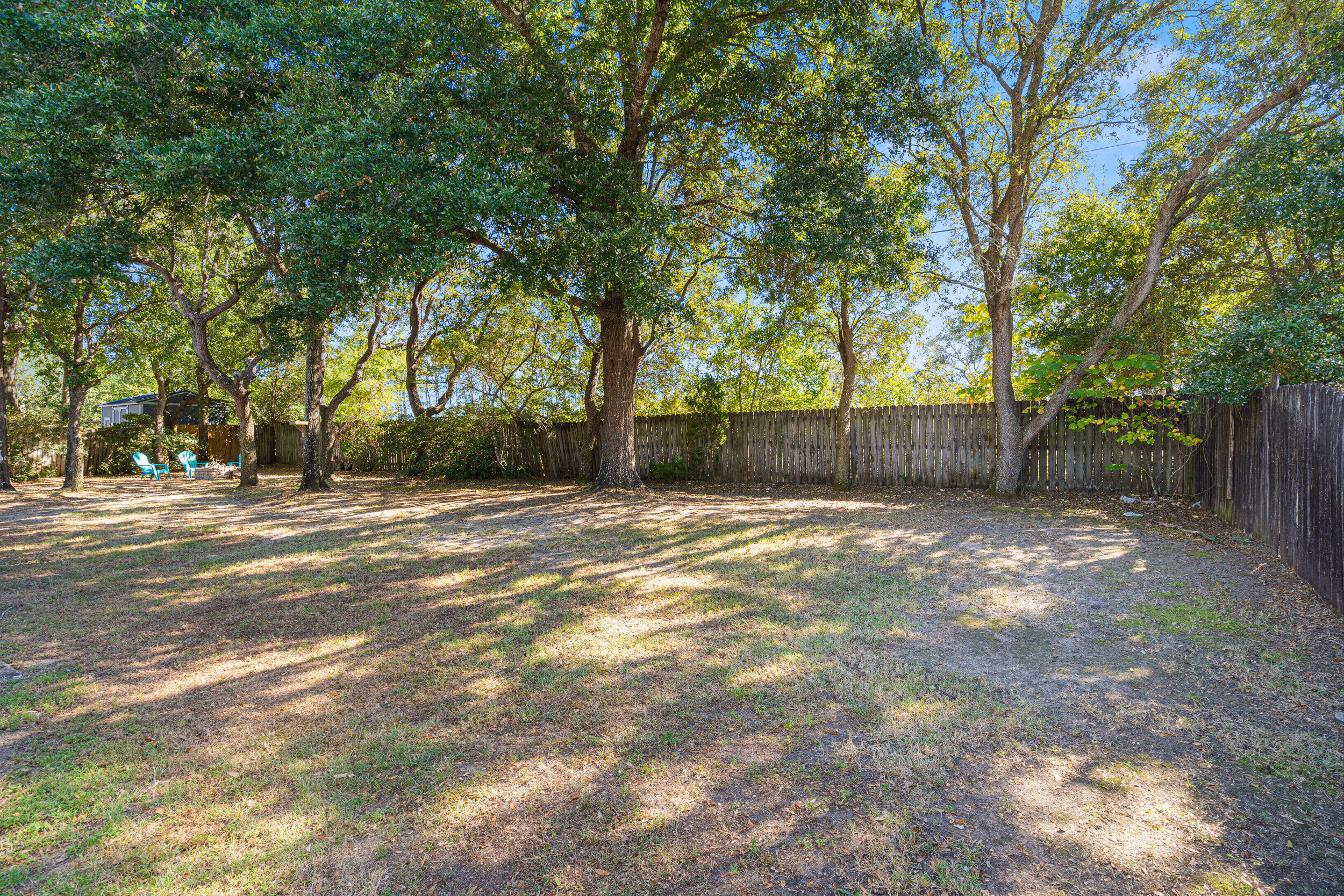 7933 Skyview Boulevard Navarre, FL 32566 - Photo 30 of 38 a backyard of a house with lots of green space