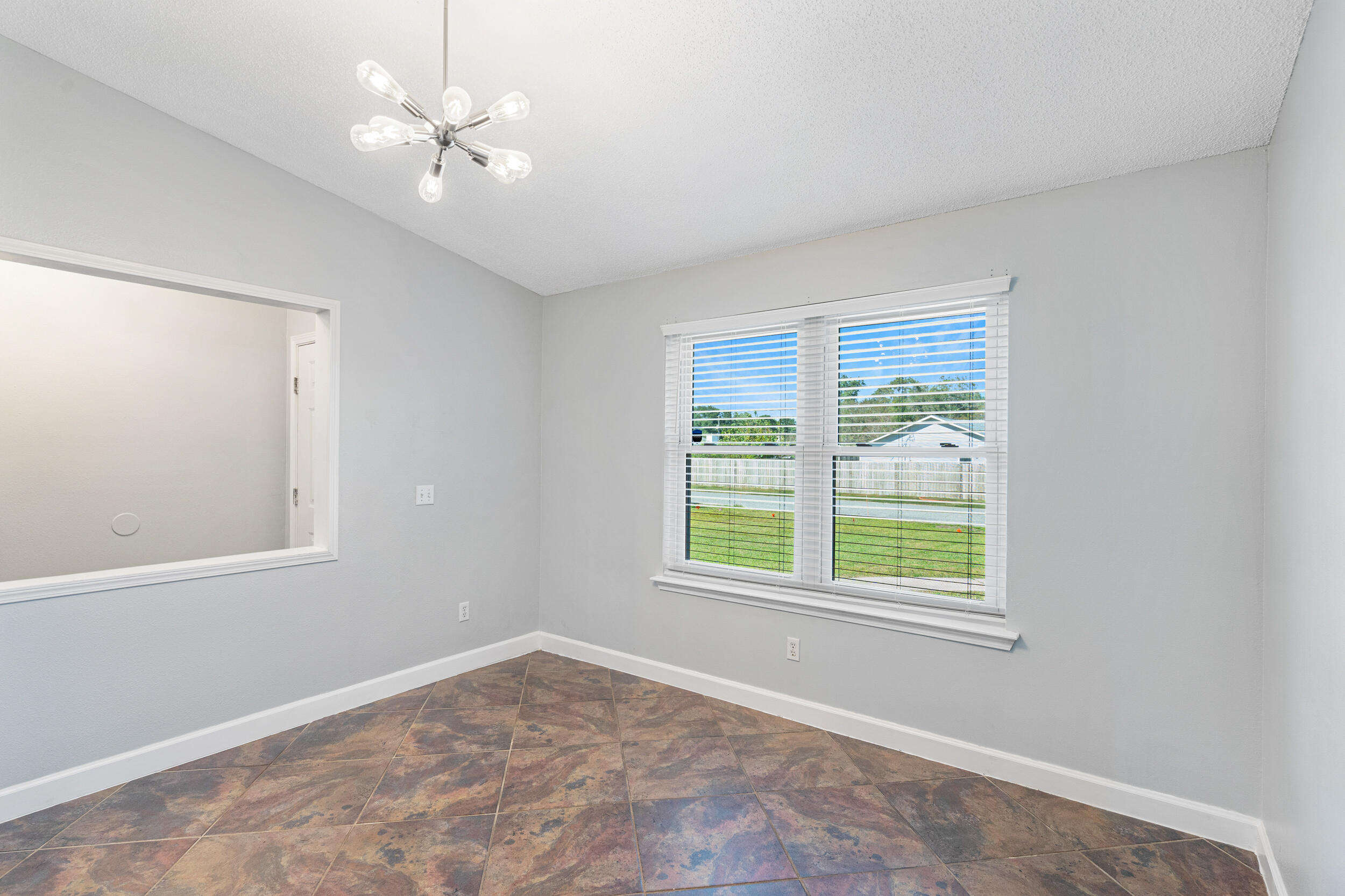 7933 Skyview Boulevard Navarre, FL 32566 - Photo 5 of 38 an empty room with a window