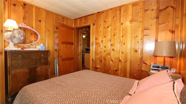 a bedroom with a bed and a lamp with the walls