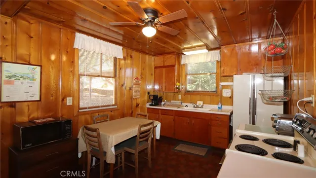 a kitchen with a table chairs and a stove