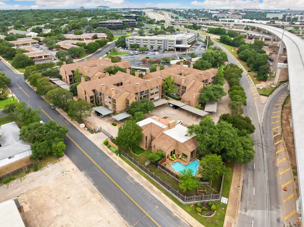an aerial view of residential houses with outdoor space