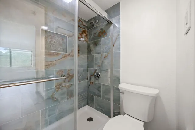 a bathroom with a double vanity sink and mirror with wooden floor