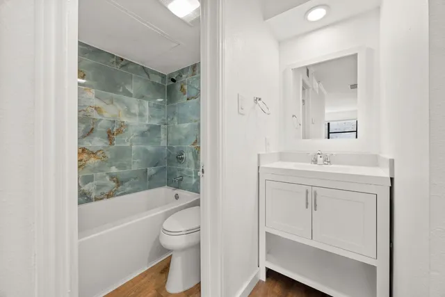 a bathroom with a toilet and bathtub