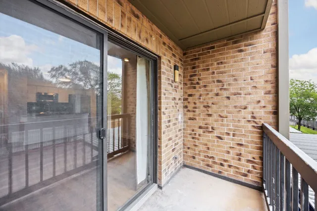 a view of a patio with a table and chairs and potted plants