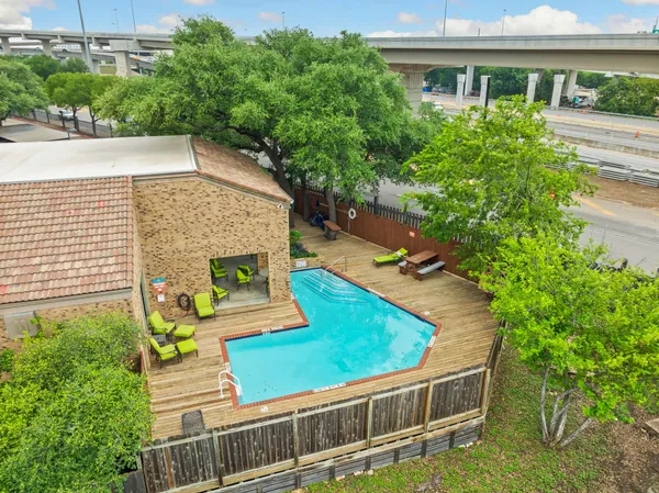 an aerial view of a house with swimming pool garden and patio