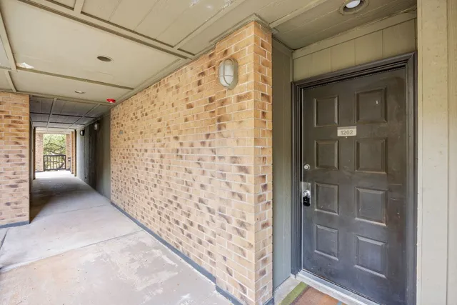 a kitchen with stainless steel appliances granite countertop a refrigerator a sink a stove a microwave and wooden floor