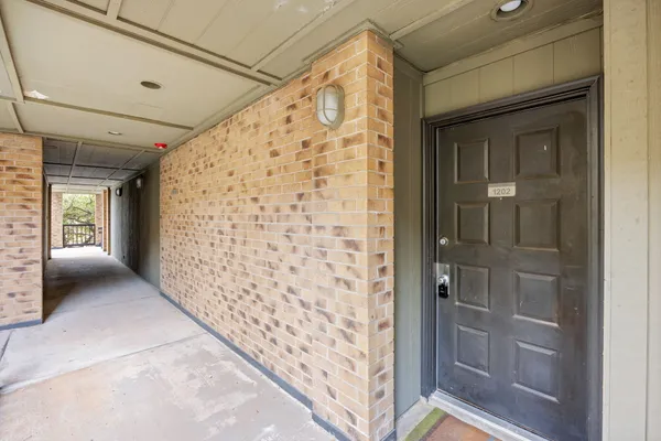 a kitchen with stainless steel appliances granite countertop a refrigerator a sink a stove a microwave and wooden floor