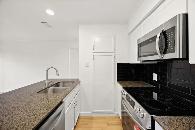 a living room with furniture a large window and wood floor