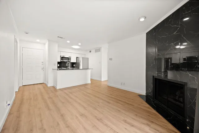 a view of an empty room with glass door and a window