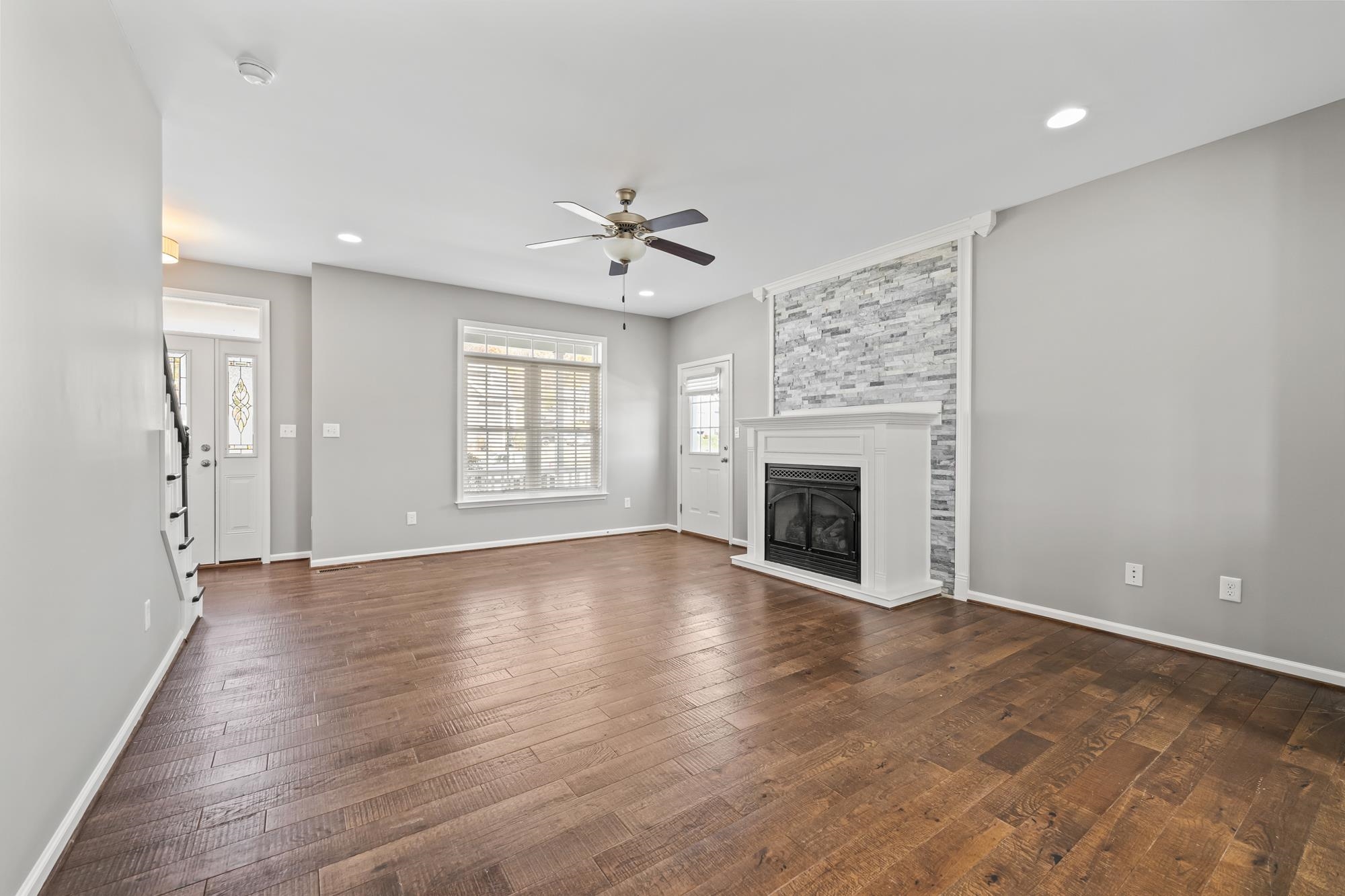 8 Mcilwee Lane Staunton, VA 24401 - Photo 9 of 56 an empty room with windows fireplace and a kitchen view