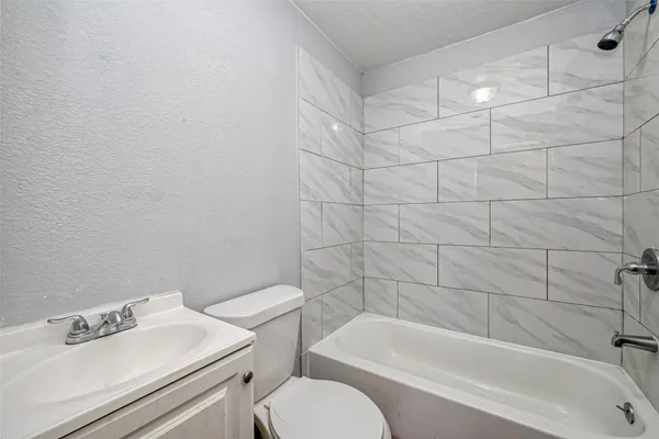 a bathroom with a sink toilet and bathtub