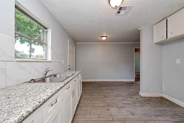 a bathroom with a granite countertop sink and dishwasher
