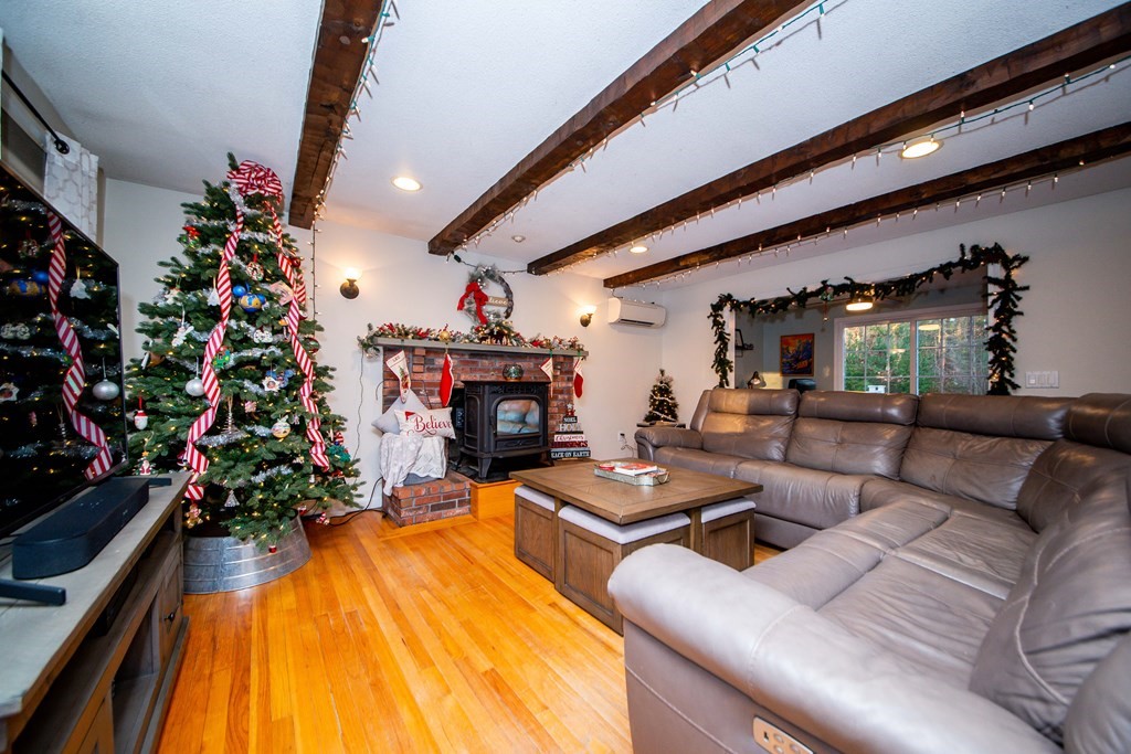 16 Gammons Road Acushnet, MA 02743 - Photo 11 of 31 a living room with furniture a flowers and a fireplace