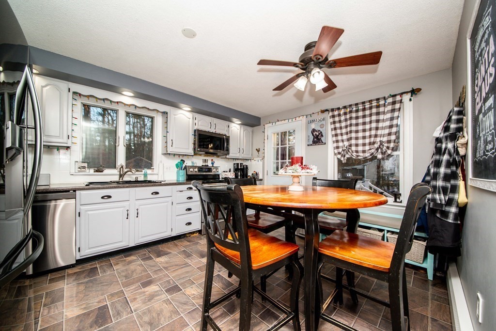 16 Gammons Road Acushnet, MA 02743 - Photo 20 of 31 a kitchen with stainless steel appliances kitchen island granite countertop a table chairs sink and cabinets
